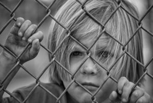 boy, kid, child, fence, sad, unhappy, looking, chain link fence, sad boy, young, caucasian, portrait